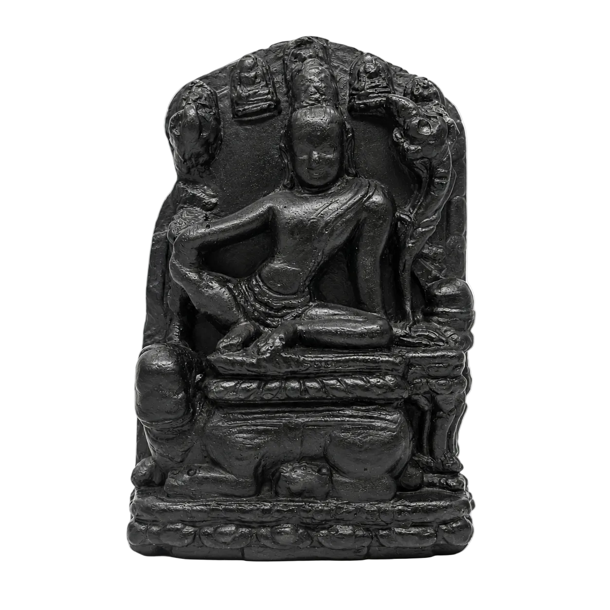 A small black stone or resin statue of a seated Buddha figure with ornate halo-like details behind it, photographed against a plain white background.
